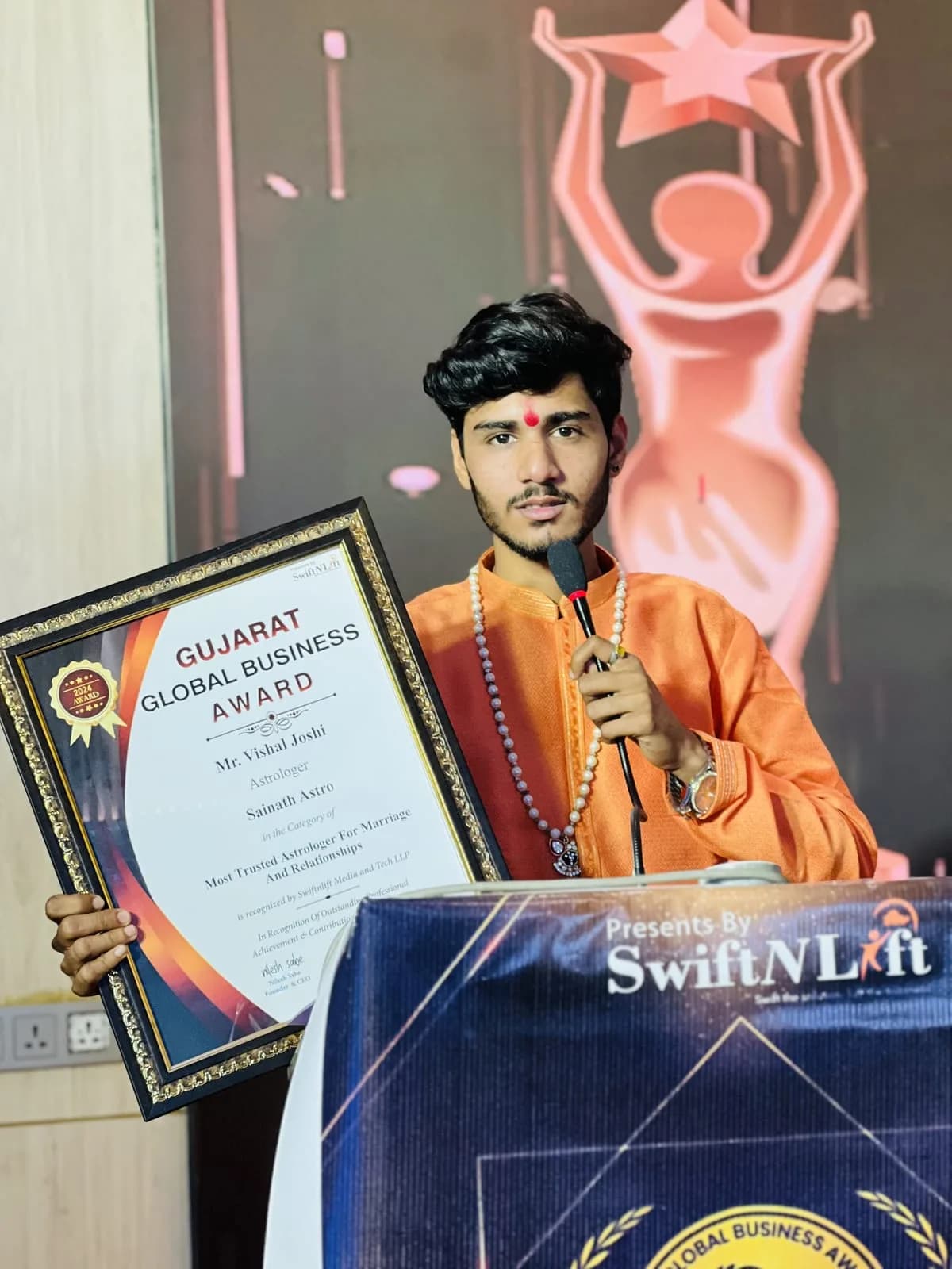 The astrologer of AstroVishalJoshi holding the Gujarat Global Business Award certificate for Most Trusted Astrologer for Marriage and Relationships